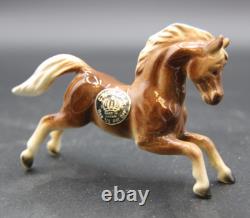 Collection of Porcelain Horse Figurines in Various Poses, Colors, and Sizes