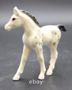 Collection of Porcelain Horse Figurines in Various Poses, Colors, and Sizes
