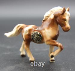 Collection of Porcelain Horse Figurines in Various Poses, Colors, and Sizes